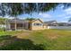 A spacious backyard features a screened patio and ample lawn space at 5123 Whispering Leaf Trl, Valrico, FL 33596