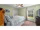 Comfortable bedroom featuring carpet floors, ceiling fan, closet, and bright green walls at 5123 Whispering Leaf Trl, Valrico, FL 33596