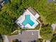 Aerial view of a community pool in a lush, tree-lined neighborhood, next to a parking lot with designated accessible spot at 5123 Whispering Leaf Trl, Valrico, FL 33596