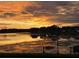 Stunning lake view featuring a heron and vibrant sunset colors reflecting on the water at 5123 Whispering Leaf Trl, Valrico, FL 33596