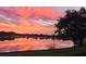 Picturesque lake view at sunset with vibrant reflections and serene surroundings at 5123 Whispering Leaf Trl, Valrico, FL 33596
