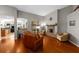 Cozy living room with hardwood floors, a brick fireplace, and ample natural light at 5123 Whispering Leaf Trl, Valrico, FL 33596
