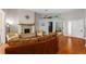 Bright living room with a brick fireplace, hardwood floors, and an open layout perfect for entertaining at 5123 Whispering Leaf Trl, Valrico, FL 33596