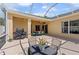 Covered patio perfect for outdoor dining and entertaining, featuring grill, ceiling fans, and ample seating at 5123 Whispering Leaf Trl, Valrico, FL 33596