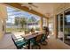 Relaxing screened patio with ceiling fans, outdoor seating, and a view of the yard at 5123 Whispering Leaf Trl, Valrico, FL 33596