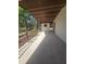 Back porch with stained-wood ceiling and railings, concrete floor, and view to back yard at 5425 Leisure St, Dade City, FL 33523