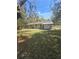 Exterior view of the back of the home showcasing the spacious backyard and covered patio area at 5425 Leisure St, Dade City, FL 33523