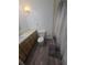 Cozy bathroom featuring a vanity, toilet, and tiled shower with a shower curtain at 5425 Leisure St, Dade City, FL 33523