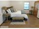 Inviting bedroom with rustic wooden accents, featuring a window and lamps for warm lighting at 5425 Leisure St, Dade City, FL 33523
