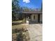 The property is located in a natural setting and features a stucco exterior, a carport, and mature trees at 5425 Leisure St, Dade City, FL 33523