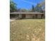 Single-story home with a carport, neutral paint, and well maintained front yard at 5425 Leisure St, Dade City, FL 33523