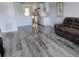 Comfortable living room features sleek gray wood floors and a modern kitchen with stainless appliances at 5725 80Th N St # 314, St Petersburg, FL 33709