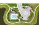 Aerial view of the community pool and parking area surrounded by lush green spaces at 607 Royal Empress Dr, Ruskin, FL 33570
