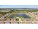 Wide aerial view of the community featuring multiple townhomes surrounding a large lake at 607 Royal Empress Dr, Ruskin, FL 33570