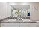 Bright bathroom featuring dual sinks with granite counters and a large mirror at 607 Royal Empress Dr, Ruskin, FL 33570