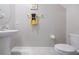 Half bathroom featuring a pedestal sink, toilet, and a gray paint at 607 Royal Empress Dr, Ruskin, FL 33570