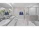 Modern bathroom with double sinks, granite countertops, and a glass-enclosed shower at 607 Royal Empress Dr, Ruskin, FL 33570