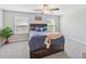 Cozy bedroom with plush carpet, natural light, and a ceiling fan at 607 Royal Empress Dr, Ruskin, FL 33570