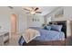 Comfortable bedroom featuring carpet, large windows, ceiling fan, and ensuite bathroom at 607 Royal Empress Dr, Ruskin, FL 33570