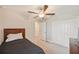 This neutral bedroom includes a ceiling fan, double door closet, and view into the hall at 607 Royal Empress Dr, Ruskin, FL 33570