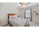 Neutral bedroom featuring a ceiling fan, window with blinds and curtains, and shelves at 607 Royal Empress Dr, Ruskin, FL 33570