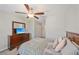 Neutral bedroom with a ceiling fan, double door closet, dresser and view of the hall at 607 Royal Empress Dr, Ruskin, FL 33570