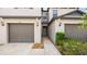 Neutral-colored two-story townhouse with a private garage and inviting entrance at 607 Royal Empress Dr, Ruskin, FL 33570