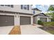Two-story townhouse with driveway and a brown garage door at 607 Royal Empress Dr, Ruskin, FL 33570