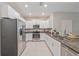Modern kitchen with stainless steel appliances, granite countertops, and white cabinetry at 607 Royal Empress Dr, Ruskin, FL 33570