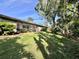 Lush backyard with a covered patio, offering serene outdoor living space at 610 S Woodlands Dr, Oldsmar, FL 34677