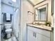 Bathroom featuring granite countertop vanity, shower and toilet at 610 S Woodlands Dr, Oldsmar, FL 34677