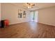 Open bedroom featuring hardwood floors, ceiling fan, and sliding door to patio at 610 S Woodlands Dr, Oldsmar, FL 34677