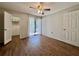 Bedroom featuring hardwood floors, closet and access to the lanai at 610 S Woodlands Dr, Oldsmar, FL 34677
