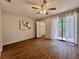 Bedroom featuring hardwood floors, closet and access to the lanai at 610 S Woodlands Dr, Oldsmar, FL 34677