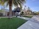 Exterior of the clubhouse entrance with manicured lawns and decorative landscaping at 610 S Woodlands Dr, Oldsmar, FL 34677