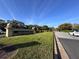 Community entrance sign with manicured lawns and street view, offering a welcoming glimpse of East Lake Woodlands at 610 S Woodlands Dr, Oldsmar, FL 34677