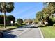 Gated community entrance, featuring lush landscaping and a security booth, ensuring privacy and exclusivity for residents at 610 S Woodlands Dr, Oldsmar, FL 34677