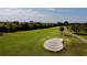 An aerial view of the well-manicured green golf course with mature trees at 610 S Woodlands Dr, Oldsmar, FL 34677