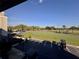 A view of the outdoor putting green and golf course, along with parking and golf carts at 610 S Woodlands Dr, Oldsmar, FL 34677