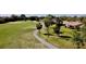 Scenic golf course view with a winding path, lush greenery, and a glimpse of nearby residences, showcasing community lifestyle at 610 S Woodlands Dr, Oldsmar, FL 34677
