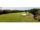 Manicured golf course view with greenery, sand trap, and palm trees at 610 S Woodlands Dr, Oldsmar, FL 34677
