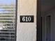 Close-up of the house number 610 next to the front door, indicating the property address at 610 S Woodlands Dr, Oldsmar, FL 34677