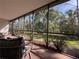 Screened lanai featuring seating and view to yard at 610 S Woodlands Dr, Oldsmar, FL 34677