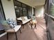 Inviting covered patio featuring wicker seating and views of lush landscaping at 610 S Woodlands Dr, Oldsmar, FL 34677