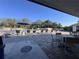 The community pool area is lined with lounge chairs and tables with umbrellas at 610 S Woodlands Dr, Oldsmar, FL 34677