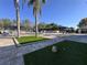 Resort-style pool area featuring lounge chairs and palm trees offers a relaxing outdoor space at 610 S Woodlands Dr, Oldsmar, FL 34677