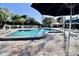 Inviting community swimming pool with lounge chairs and umbrellas, perfect for relaxation and recreation at 610 S Woodlands Dr, Oldsmar, FL 34677