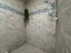 Modern shower featuring decorative tile accents and pebble floor at 610 S Woodlands Dr, Oldsmar, FL 34677