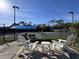 Relaxing view of community tennis courts with seating, perfect for spectators at 610 S Woodlands Dr, Oldsmar, FL 34677