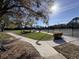 View of the tennis courts with sidewalks and a covered picnic area, perfect for players and spectators alike at 610 S Woodlands Dr, Oldsmar, FL 34677